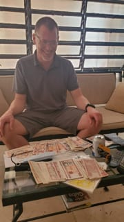 Person sitting with currency laid out